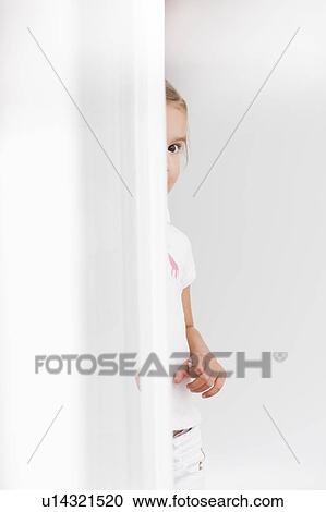 young girl looking around corner View Large Photo Image Stock Image - young girl looking around corner. Fotosearch
