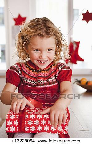 young girl opening present View Large Photo Image Picture - young girl opening present. Fotosearch