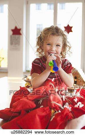 Picture - young girl playing with toy gifts. Fotosearch