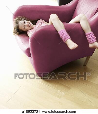 young girl relaxing upside-down in chair View Large Photo Image Stock Image - young girl relaxing upside-down in chair. Fotosearch