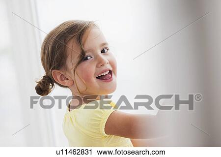 Stock Image - young girl smiling at viewer. Fotosearch