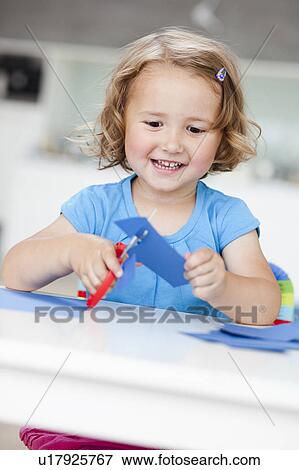 young girl using paper and scissors View Large Photo Image Stock Photo - young girl using paper and scissors. Fotosearch
