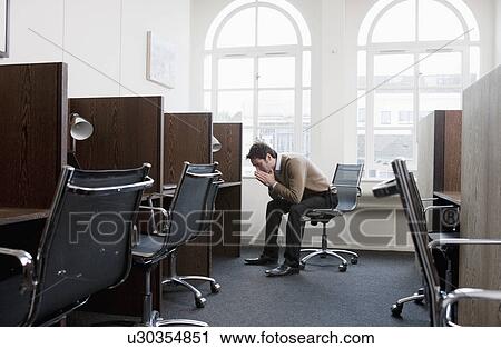 Young man at a workstation, worried View Large Photo Image Stock Image - Young man at a workstation, worried. Fotosearch