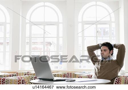 Stock Photo - Young man gazing into laptop. Fotosearch