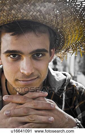 Stock Image - Young man Portrait under heavy sun. Fotosearch