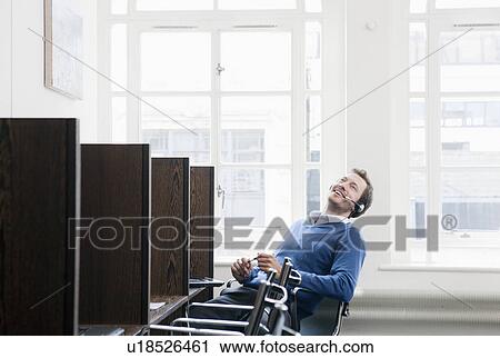 Young man working at a work station View Large Photo Image Stock Image - Young man working at a work station. Fotosearch