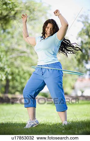 young plump girl doing hula hoop View Large Photo Image Stock Image - young plump girl doing hula hoop. Fotosearch