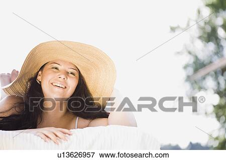young plump girl lying on a sun lounger View Large Photo Image Stock Photo - young plump girl lying on a sun lounger. Fotosearch