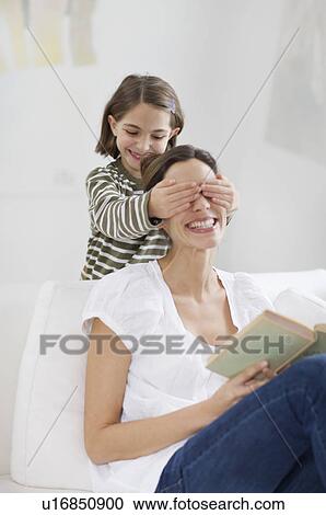 Stock Image - young woman and little girl having fun. Fotosearch