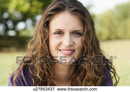 Stock Photo - young woman in park portrait. Fotosearch