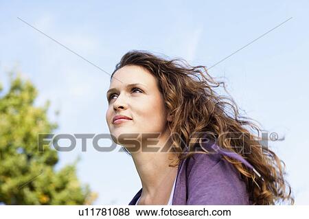 young woman looking in to sky View Large Photo Image Stock Photo - young woman looking in to sky. Fotosearch