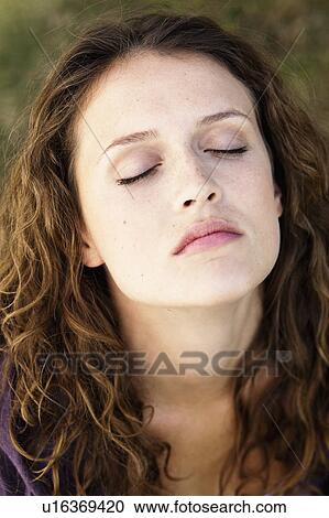 Stock Image - young woman portrait closed eyes. Fotosearch