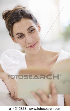 Stock Photo - young woman reading a book. Fotosearch