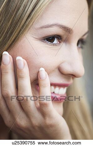 Young woman resting head on hand View Large Photo Image Stock Photography - Young woman resting head on hand. Fotosearch