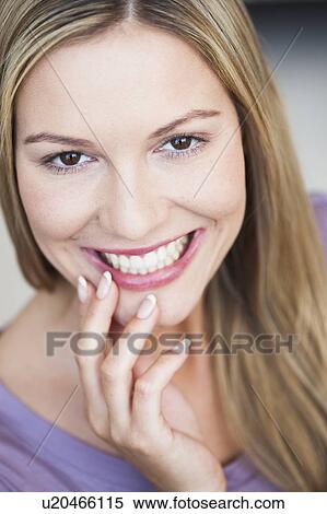 Young woman showing her teeth View Large Photo Image Stock Photography - Young woman showing her teeth. Fotosearch