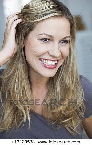 Young woman smiling feeling flattered View Large Photo Image Stock Photo - Young woman smiling feeling flattered. Fotosearch