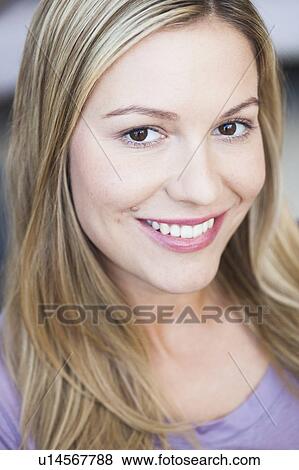 Young woman smiling View Large Photo Image Stock Photo - Young woman smiling. Fotosearch
