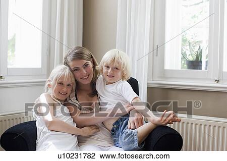Stock Image - young woman with brother and sister. Fotosearch