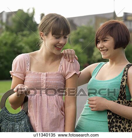 2 young woman laughing with bags View Large Photo Image Stock Photography - 2 young woman laughing with bags. Fotosearch
