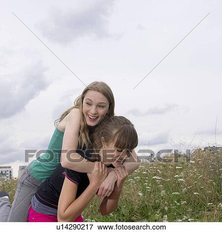 2 young women fooling around View Large Photo Image Stock Photo - 2 young women fooling around. Fotosearch