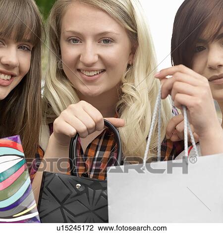 3 young women with paper bags View Large Photo Image Stock Image - 3 young women with paper bags. Fotosearch