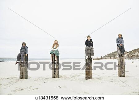 4 Children sitting on top of posts View Large Photo Image Stock Photo - 4 Children sitting on top of posts. Fotosearch