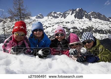 5 kids lying in the snow. View Large Photo Image Stock Image - 5 kids lying in the snow.. Fotosearch