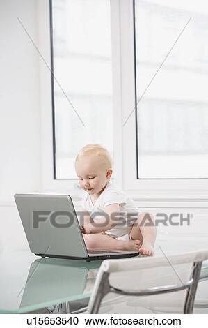 A baby working on a laptop View Large Photo Image Stock Image - A baby working on a laptop. Fotosearch