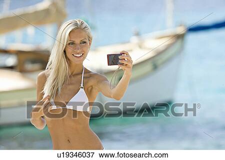 A blond female posing for the camera View Large Photo Image Stock Photo - A blond female posing for the camera. Fotosearch