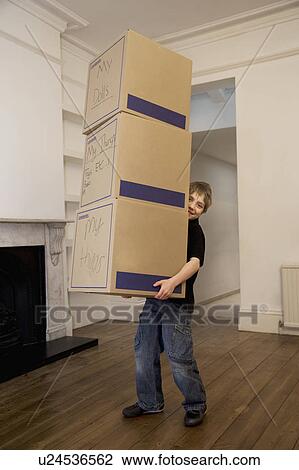 A boy holding a stack of three boxes View Large Photo Image Stock Image - A boy holding a stack of three boxes. Fotosearch