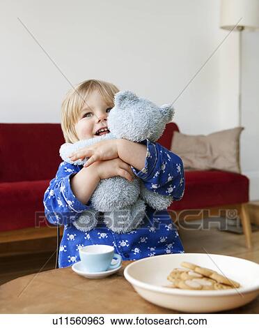 Stock Image - A boy toddler cuddling his teddy bear. Fotosearch