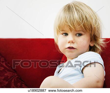 A boy toddler on a sofa View Large Photo Image Stock Photo - A boy toddler on a sofa. Fotosearch