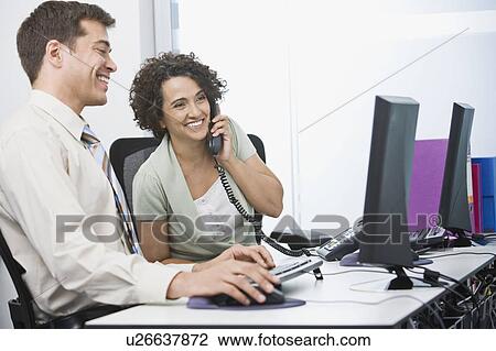 A business couple laughing at work View Large Photo Image Stock Image - A business couple laughing at work. Fotosearch