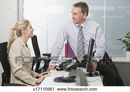 Stock Image - A business couple talking. Fotosearch