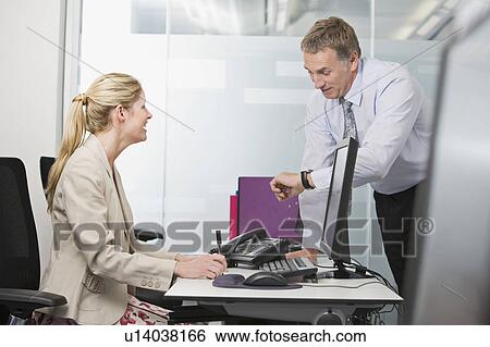 Stock Photograph - A business couple talking. Fotosearch