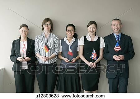A business group holding flags View Large Photo Image Stock Photo - A business group holding flags. Fotosearch