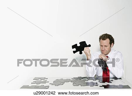 A business man doing a jigsaw View Large Photo Image Stock Image - A business man doing a jigsaw. Fotosearch