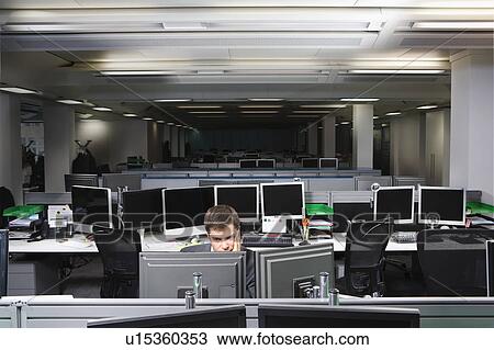 Stock Image - A business man working late. Fotosearch