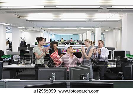Stock Photo - A business man's birthday at the office. Fotosearch