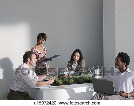 Stock Image - A business meeting on a green theme. Fotosearch