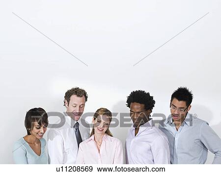 Stock Photo - A business team admiring work. Fotosearch