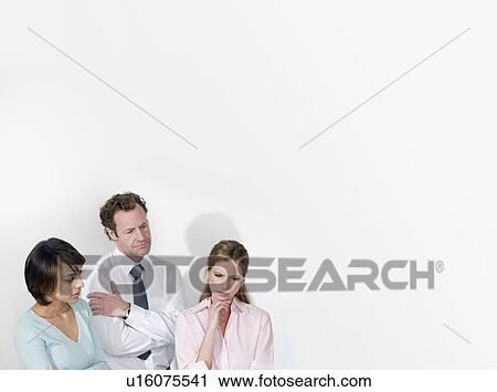 Stock Image - A business trio deliberating. Fotosearch