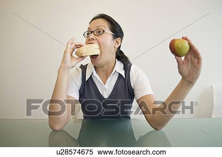 A business woman eating a sandwich View Large Photo Image Stock Photography - A business woman eating a sandwich. Fotosearch