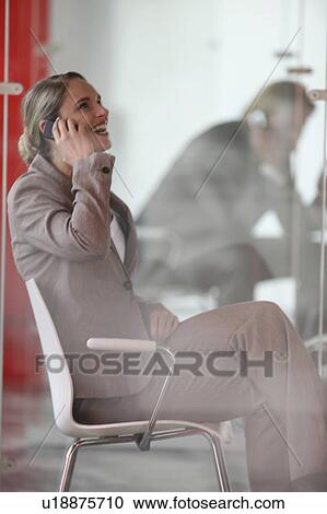 Stock Image - A businesswoman with cell-phone. Fotosearch