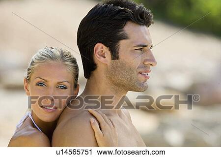 A couple embracing on the beach View Large Photo Image Stock Image - A couple embracing on the beach. Fotosearch