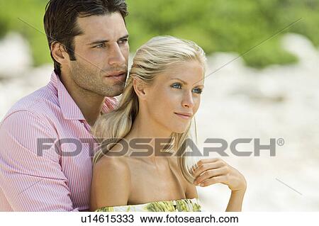 Stock Image - A couple embracing on the beach. Fotosearch