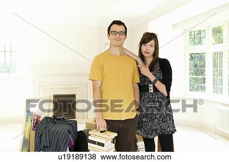 Stock Photo - A couple posing with packed belongings. Fotosearch