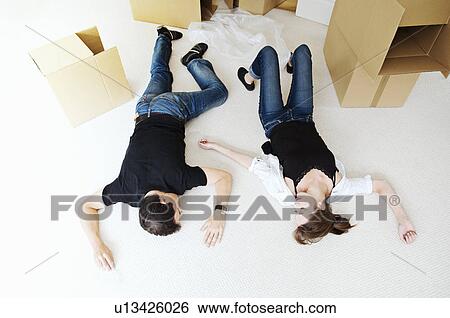 Stock Photograph - A couple surrounded by cardboard boxes. Fotosearch