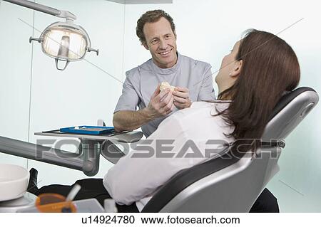 A dentist in surgery with a patient View Large Photo Image Stock Image - A dentist in surgery with a patient. Fotosearch
