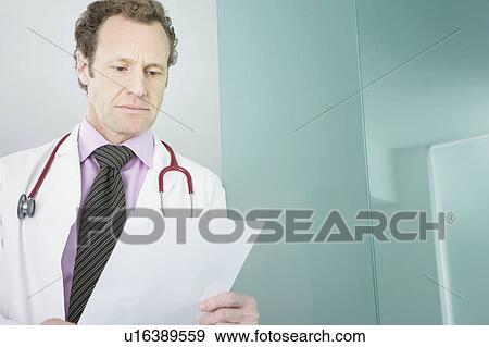 Stock Photo - A doctor reading some notes. Fotosearch